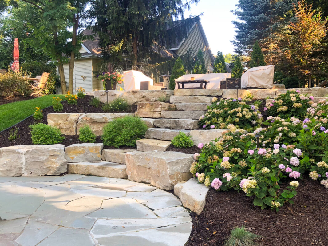 Natural stone retaining wall and steps, landscaping